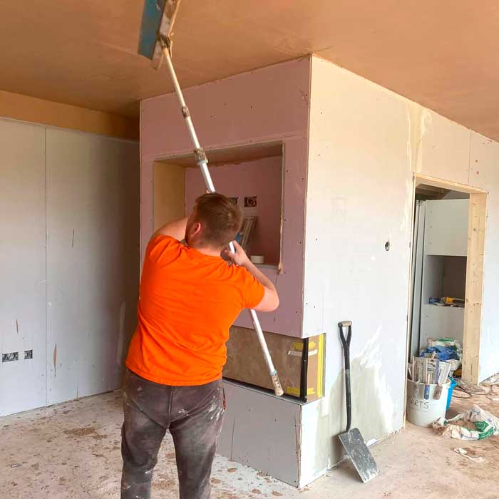 Plastering work being carried out by workmen